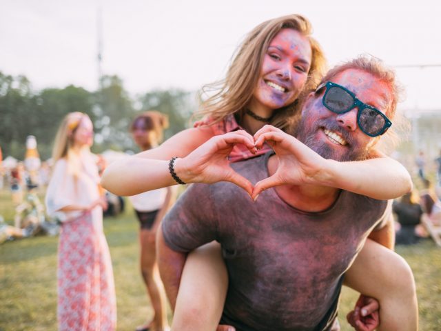 beautiful-couple-covered-in-colorful-powder-having-fun-at-summer-holi-festival.jpg